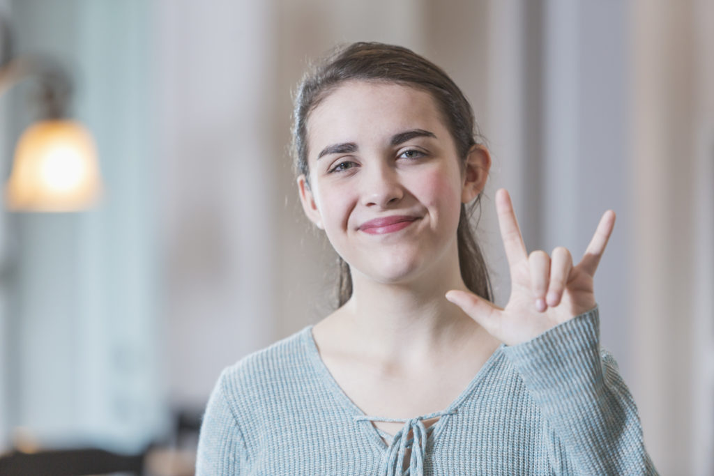 teenage-girl-saying-i-love-you-in-sign-language-ultratec